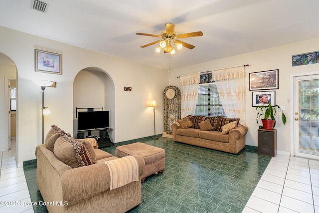 living room with ceiling fan and tile patterned floors