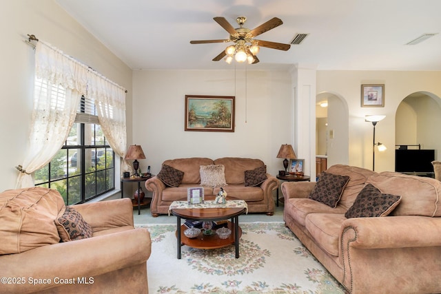 living room featuring ceiling fan and light colored carpet