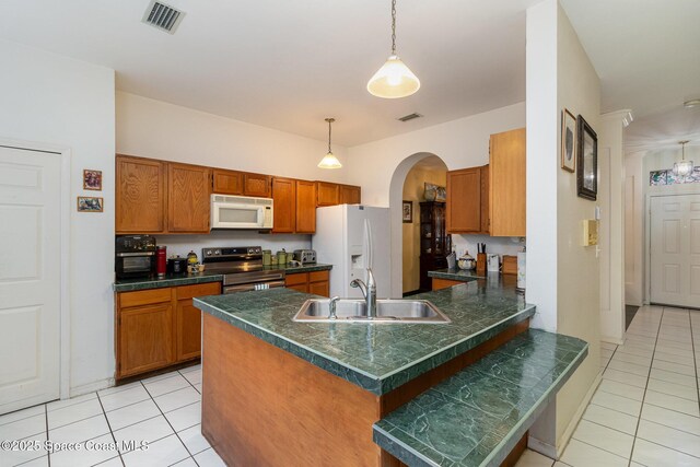 kitchen featuring decorative light fixtures, kitchen peninsula, white appliances, a kitchen breakfast bar, and light tile patterned floors