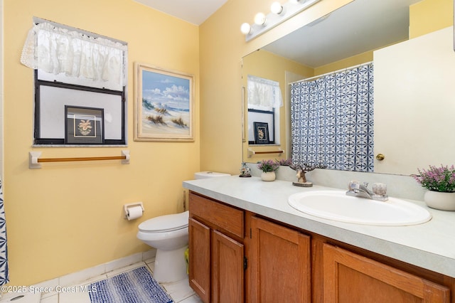 bathroom featuring toilet, tile patterned flooring, and vanity