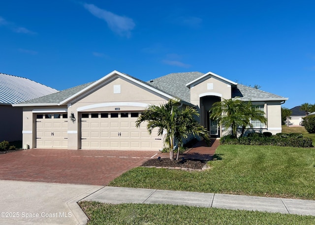 view of front of home with a front lawn and a garage