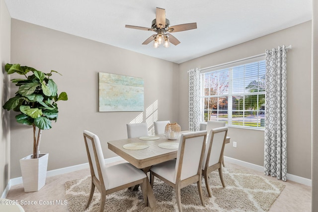 tiled dining space with ceiling fan