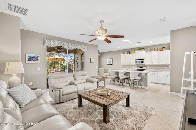 living room featuring ceiling fan and light tile patterned flooring