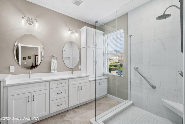 bathroom featuring tile patterned flooring, walk in shower, and vanity