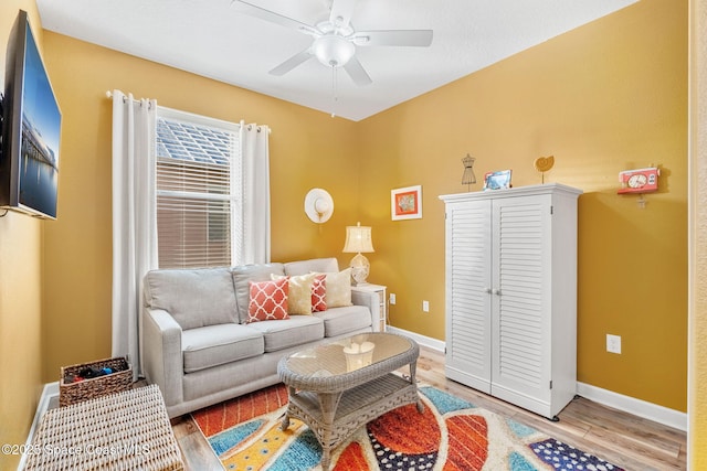 living room featuring ceiling fan and light hardwood / wood-style flooring