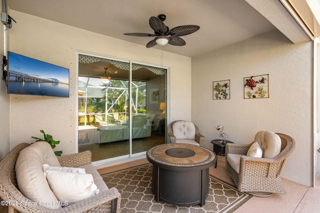 view of patio / terrace featuring ceiling fan and an outdoor living space with a fire pit