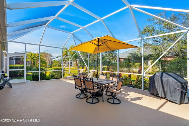 view of patio with glass enclosure and area for grilling