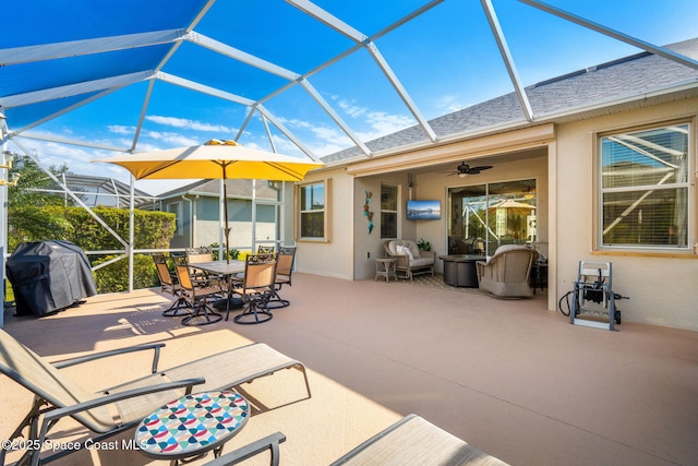 view of patio / terrace featuring glass enclosure, ceiling fan, and grilling area