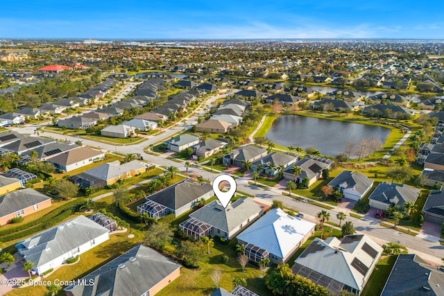 birds eye view of property with a water view