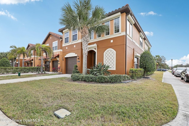 mediterranean / spanish-style house featuring a garage and a front yard