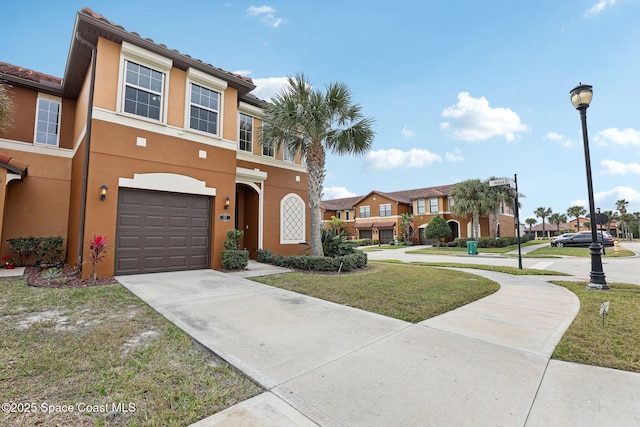 view of front facade with a front yard and a garage