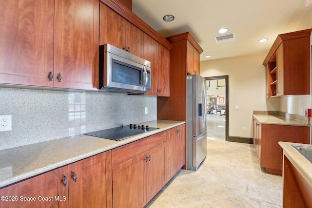 kitchen with stainless steel appliances and decorative backsplash