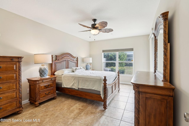 tiled bedroom featuring ceiling fan