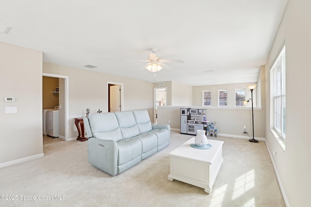 living room with light colored carpet and ceiling fan