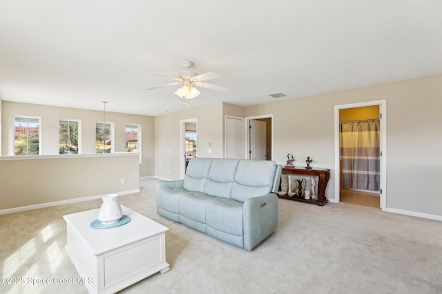 carpeted living room featuring ceiling fan