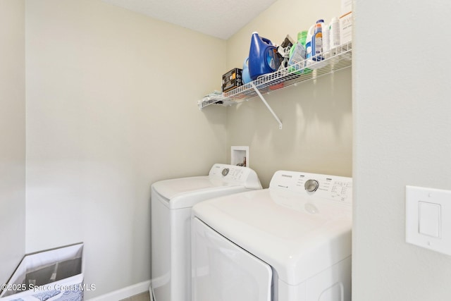 laundry room with washing machine and clothes dryer