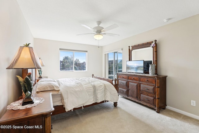 bedroom featuring light colored carpet and ceiling fan