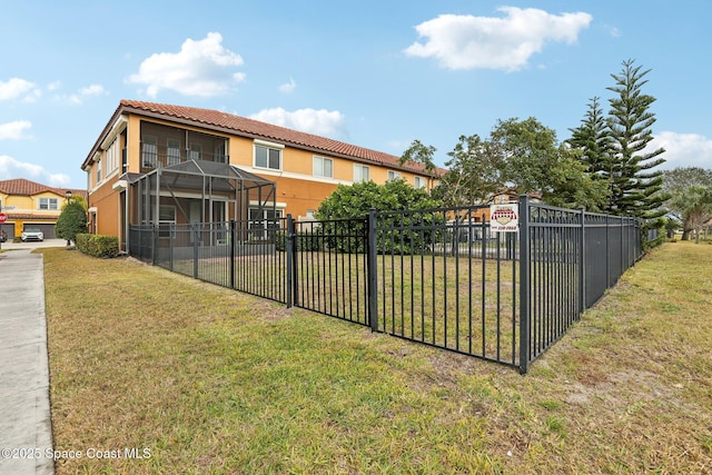 exterior space with a yard and glass enclosure