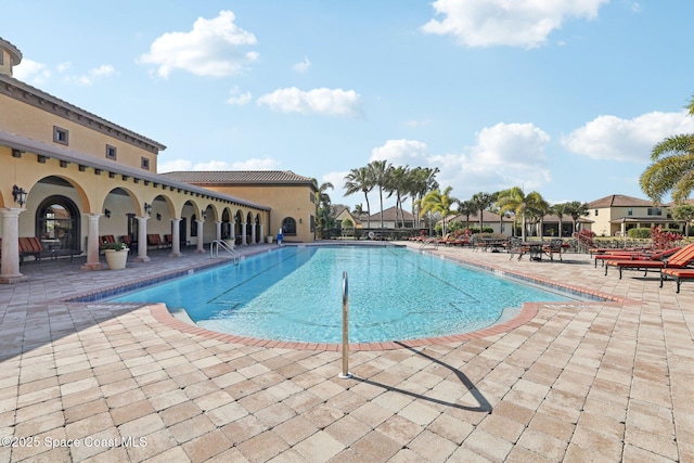 view of swimming pool with a patio area