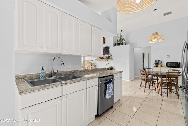 kitchen with decorative light fixtures, white cabinetry, sink, light tile patterned floors, and stainless steel dishwasher