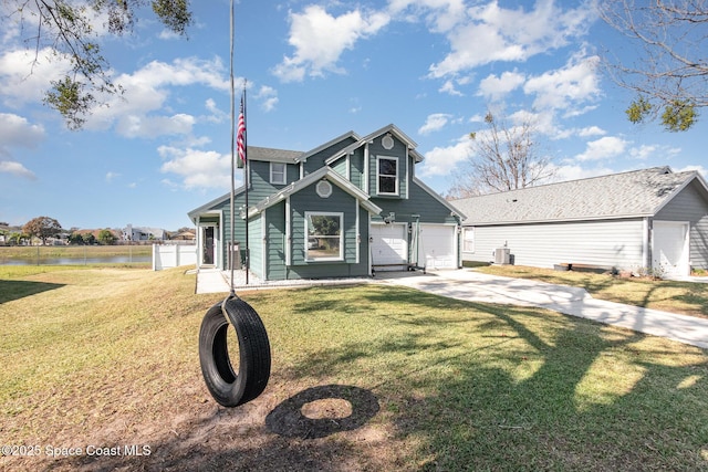 view of front of home featuring a front yard, a garage, and a water view