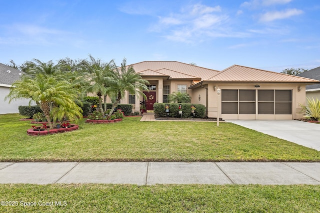 view of front of property featuring a front yard and a garage