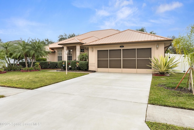 view of front of home with a front lawn and a garage