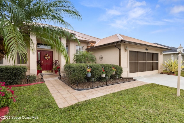 view of front of house with a front yard and a garage