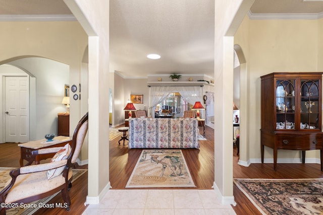 foyer featuring light tile patterned flooring and crown molding