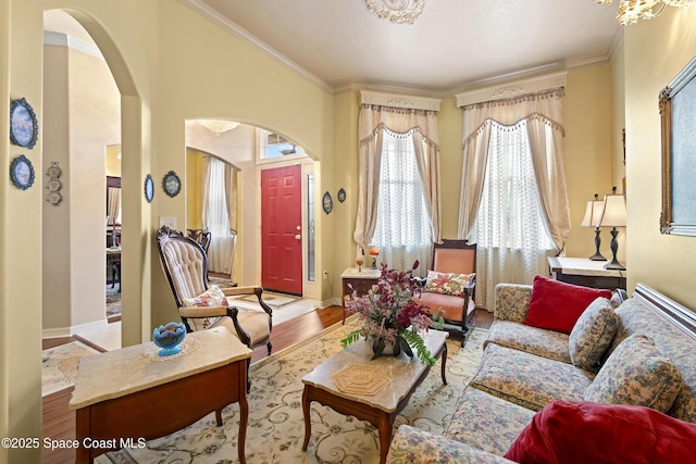 living area with light wood-type flooring and crown molding