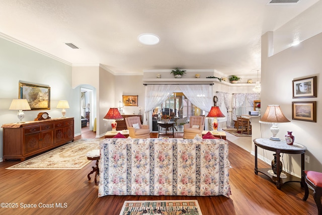 living room featuring crown molding and hardwood / wood-style flooring