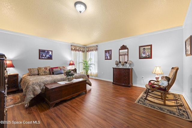 bedroom featuring a textured ceiling, dark hardwood / wood-style flooring, and ornamental molding