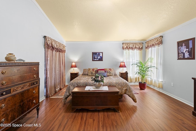 bedroom featuring crown molding and hardwood / wood-style floors