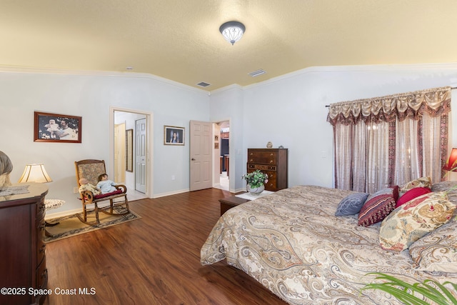 bedroom with hardwood / wood-style floors, ornamental molding, and vaulted ceiling