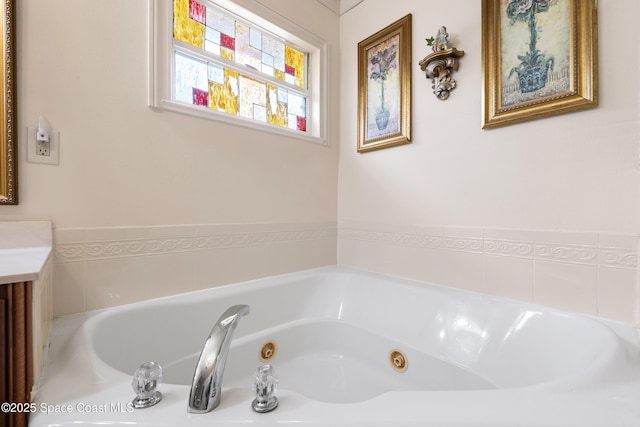 bathroom featuring a washtub and vanity