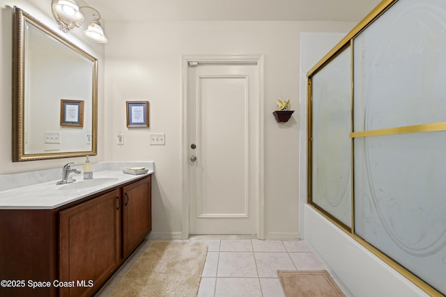 bathroom featuring enclosed tub / shower combo, vanity, and tile patterned floors