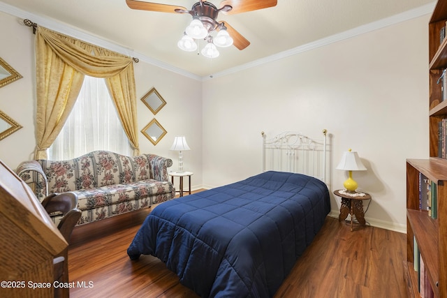 bedroom featuring hardwood / wood-style flooring, crown molding, and ceiling fan