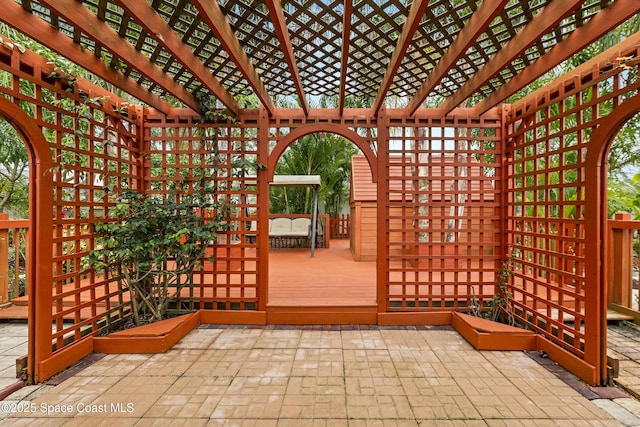 wooden terrace with a patio and a pergola