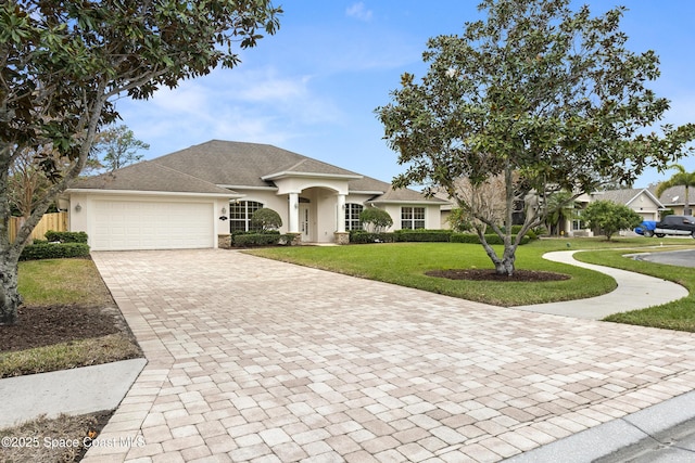 view of front of property with a front yard and a garage