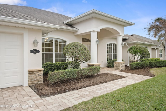 view of exterior entry featuring a garage