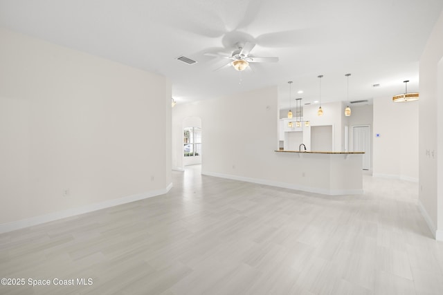 unfurnished living room featuring ceiling fan