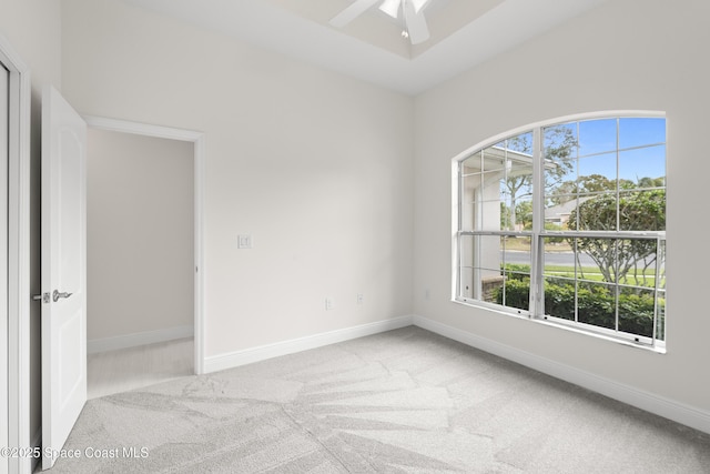 unfurnished room featuring ceiling fan and light colored carpet