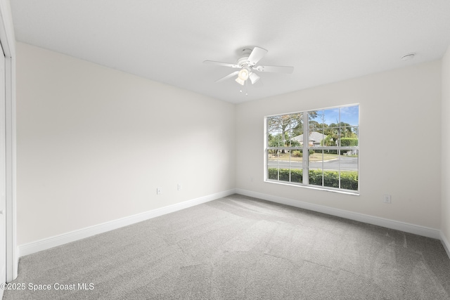 empty room featuring carpet floors and ceiling fan