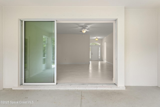 property entrance with ceiling fan