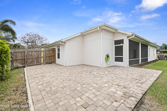 back of house featuring a patio area, cooling unit, and a sunroom