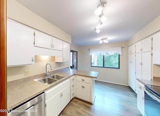 kitchen featuring kitchen peninsula, white cabinetry, and stainless steel appliances