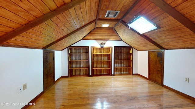 additional living space with wooden ceiling, light wood-type flooring, and vaulted ceiling with beams