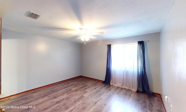 empty room featuring light hardwood / wood-style flooring and ceiling fan