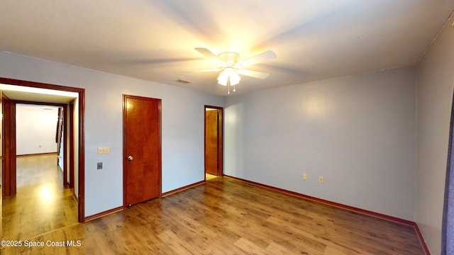 unfurnished bedroom with ceiling fan and light hardwood / wood-style flooring