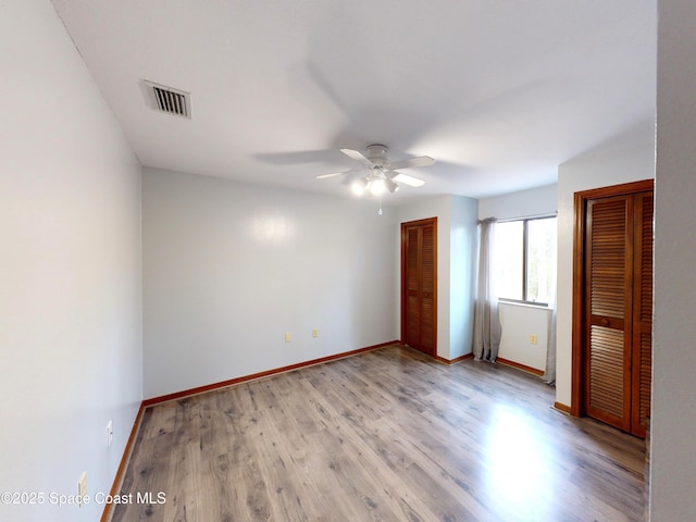 unfurnished bedroom featuring light wood-type flooring and ceiling fan